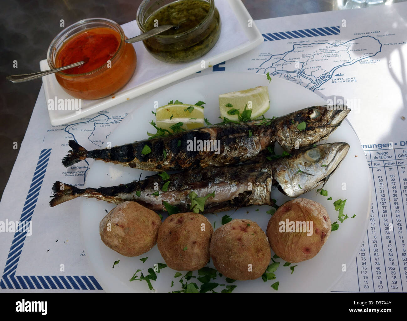 Typical lunch of sardines and papas arrugadas with mojo sauces in Tenerife, Canary Islands, Spain Stock Photo