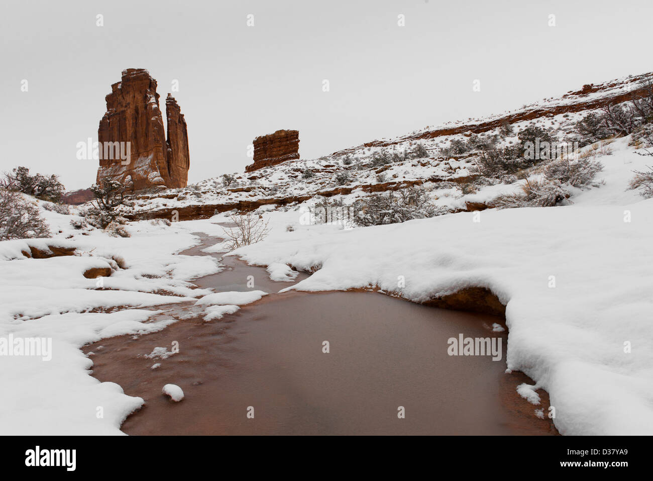 During winter, slush cascades down Park Avenue in Arches National Park ...