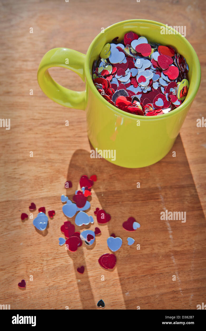 Creative still life of a mug full of love hearts. Stock Photo
