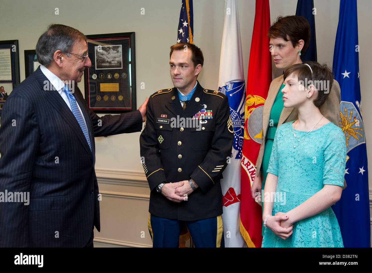 Pentagon, Arlington, Virginia. 12th February 2013. US Secretary of Defense Leon Panetta welcomes Army Staff Sergeant Clinton Romesha and his family at the Pentagon, February 12, 2013 in Arlington, VA. Romesha was presented the Medal of Honor yesterday at the White House for heroism in combat in Afghanistan.Credit: DOD Photo / Alamy Live News Stock Photo