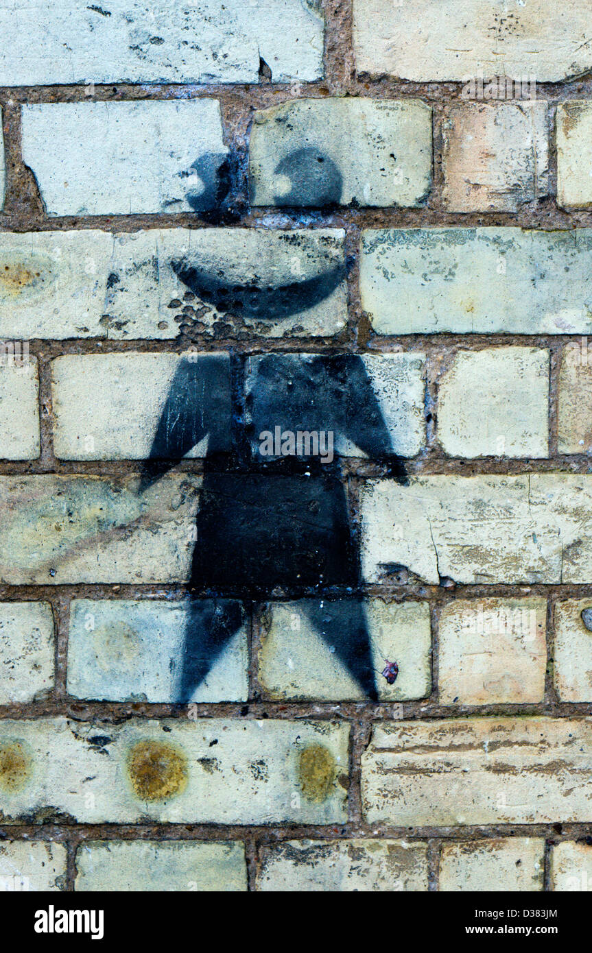 Spray painted graffiti on a brick wall. Stock Photo