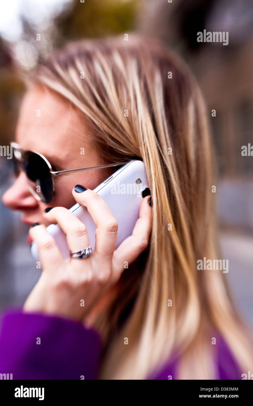 Young Woman talking on phone outside on a Fall Day Stock Photo