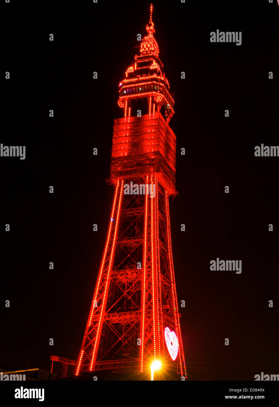 Blackpool,UK 12th Febuary 2013   The all new LED lighting on Blackpool tower is switched on for the first time after the legs have been in darkness for several years after major maintenance and refurbishment work was carried out.The iconic structure will shine bright red for the next few days to celebrate Valentine's day,Credit: kevin walsh / Alamy Live News Stock Photo