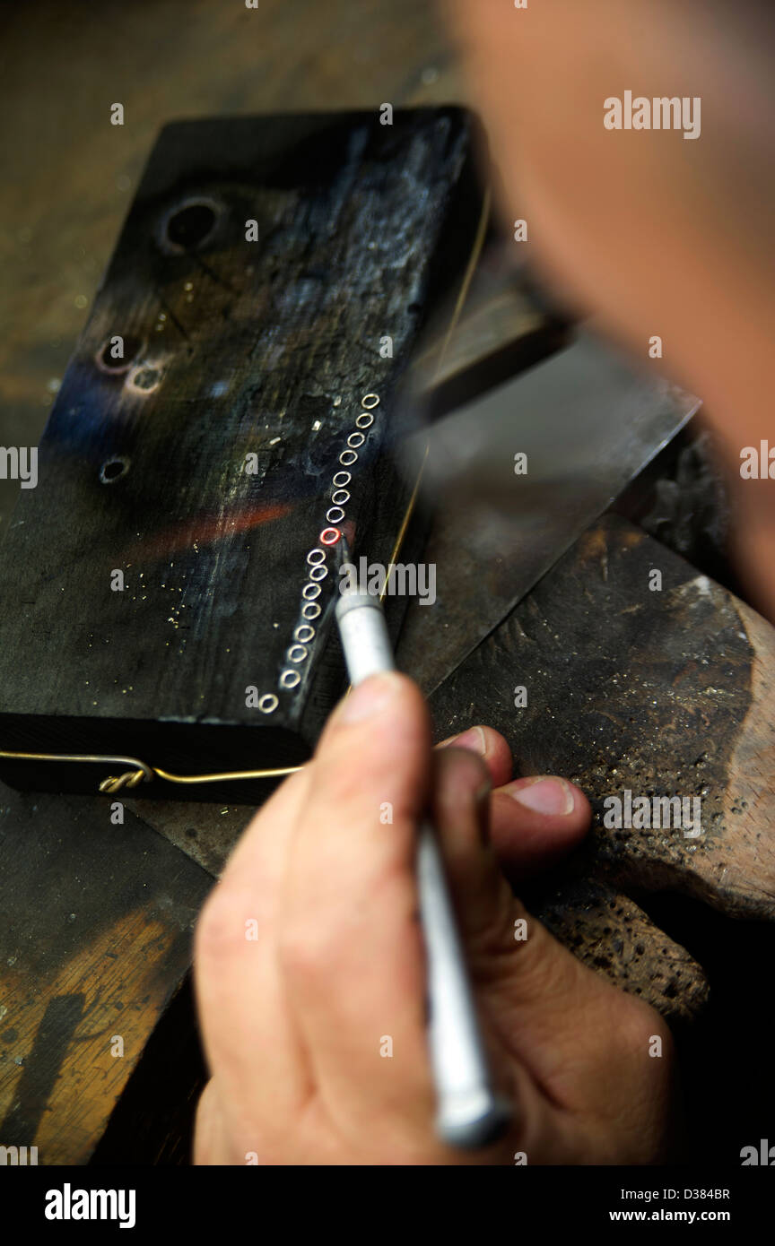 Craftsman using blow torch to heat metal to make rings Stock Photo Alamy