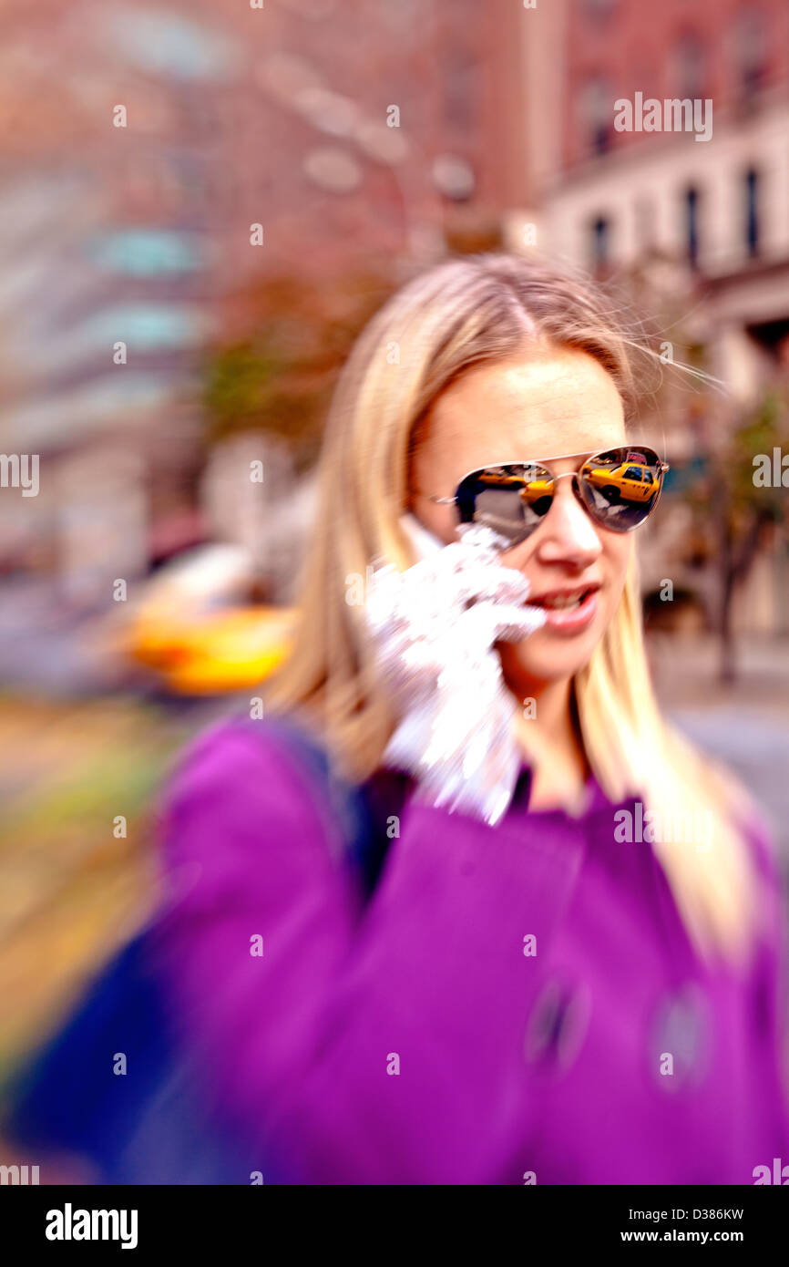 Young Woman talking on phone outside on a Fall Day Stock Photo
