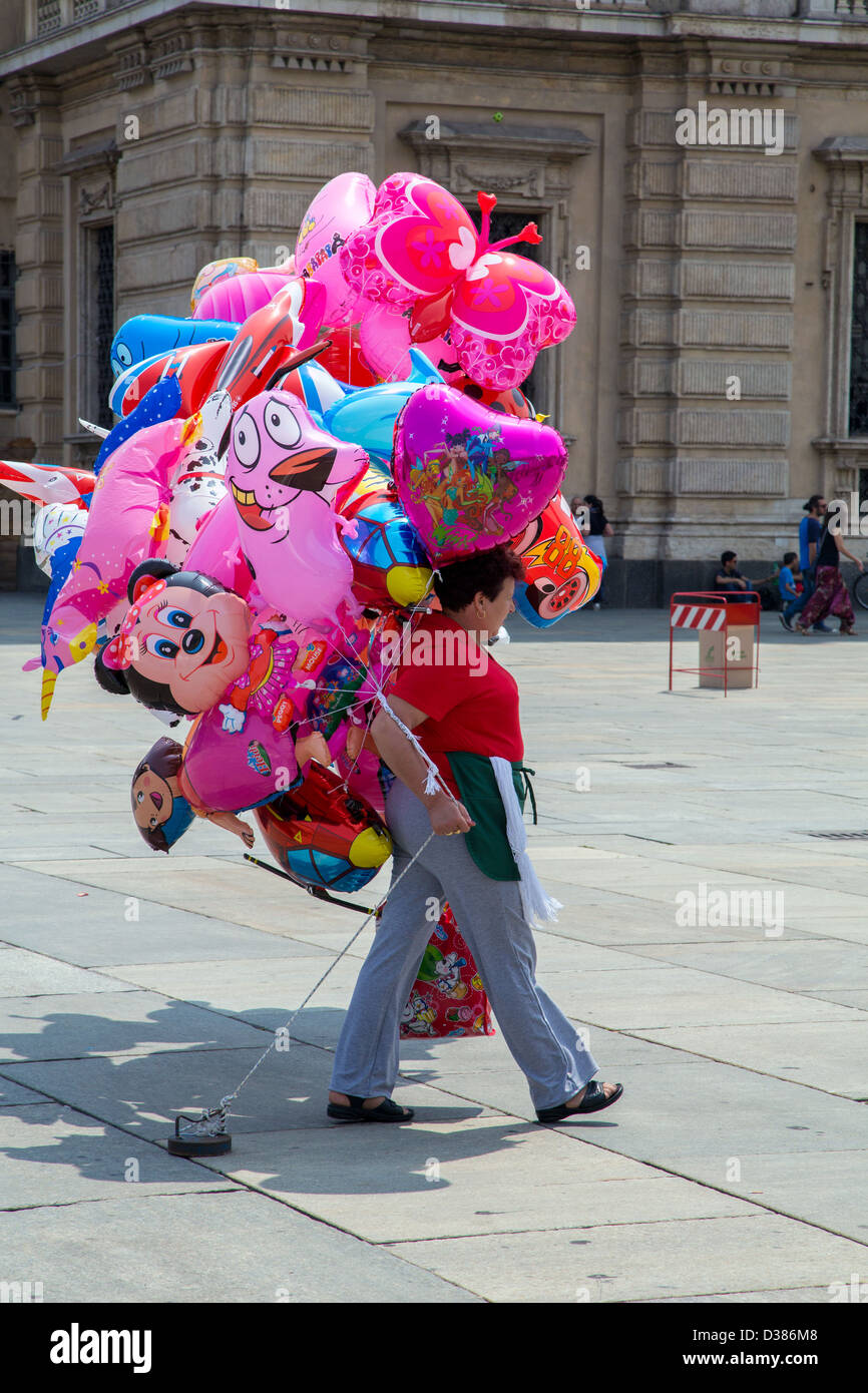 Woman with colourful novelty balloons in Turin Italy Stock Photo - Alamy