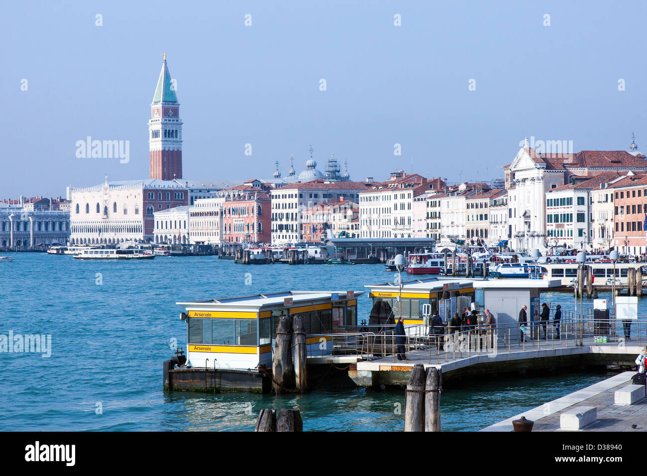 The 'Arsenale' water taxi stop on the Canale di San Marco, Venice in the sunshine with St Mark's Campanile in the background. Stock Photo