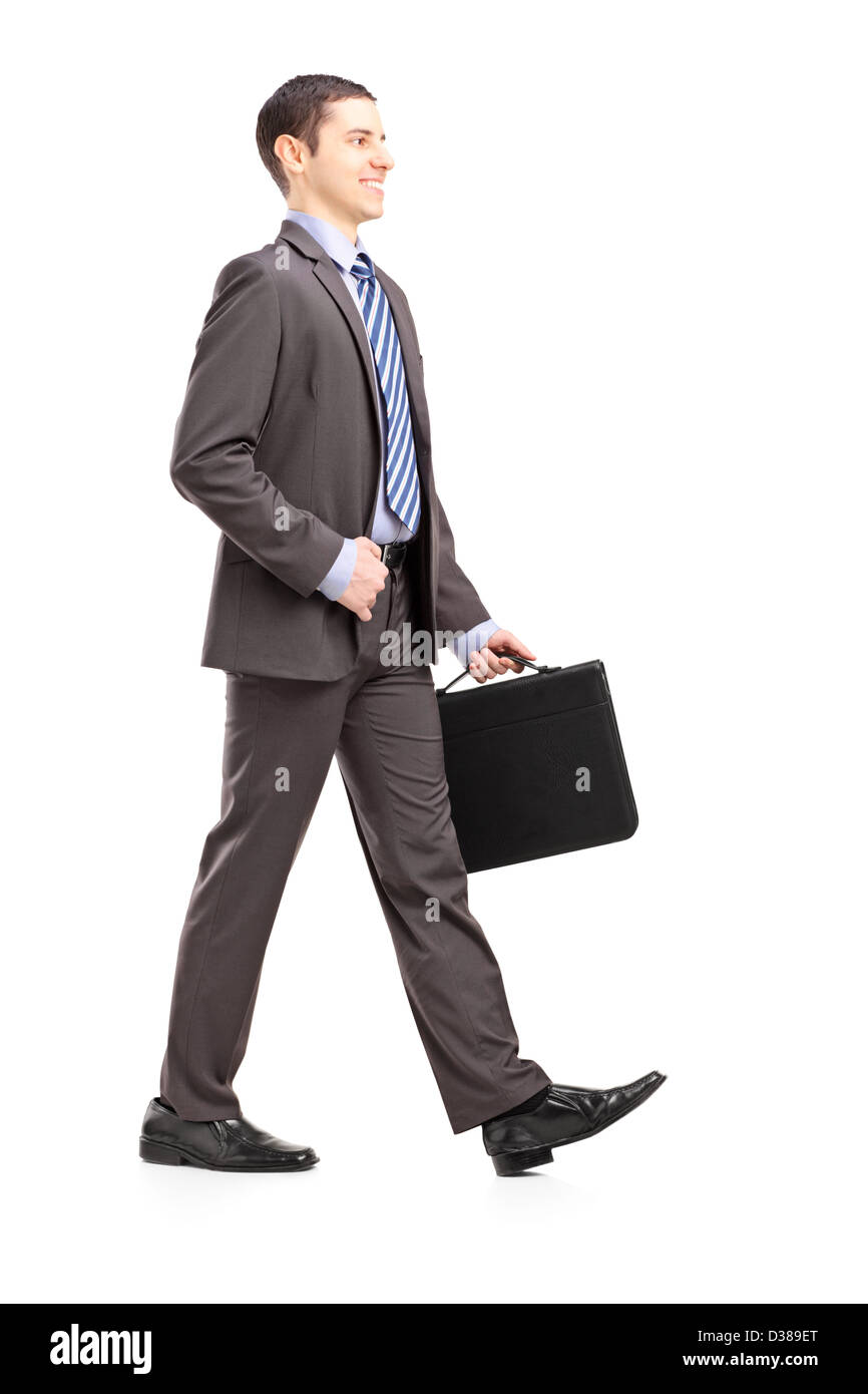 Full length portrait of a young businessman with briefcase walking
