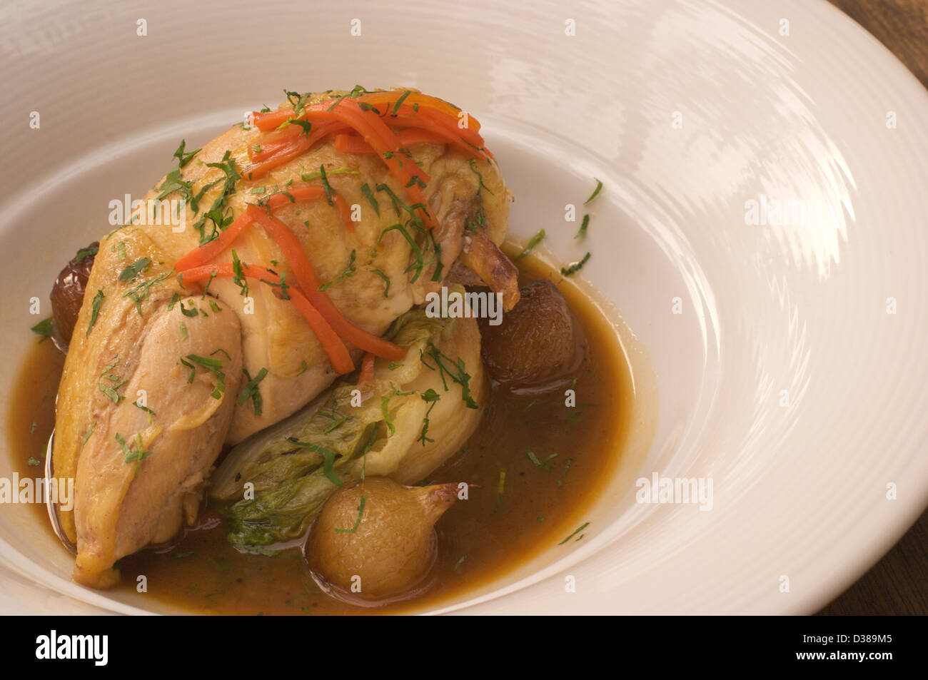 Pot roasted chicken with braised baby gem lettuce and pearl onions Stock Photo