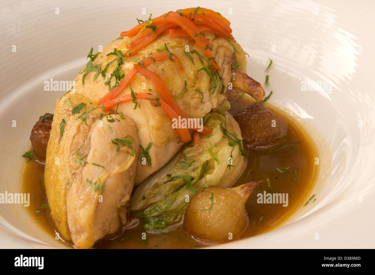Pot roasted chicken with braised baby gem lettuce and pearl onions Stock Photo