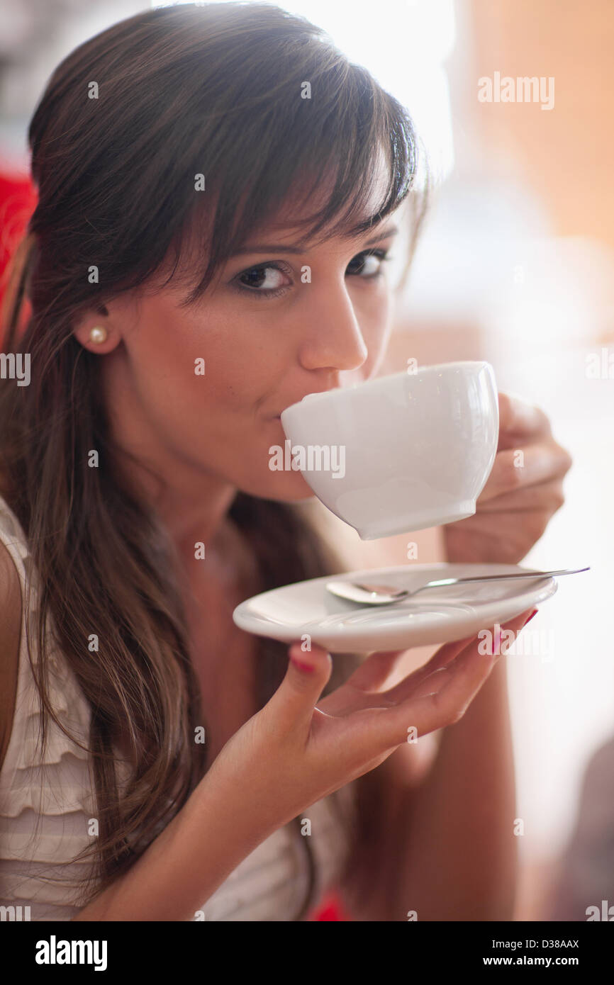 Woman drinking coffee in cafe Stock Photo