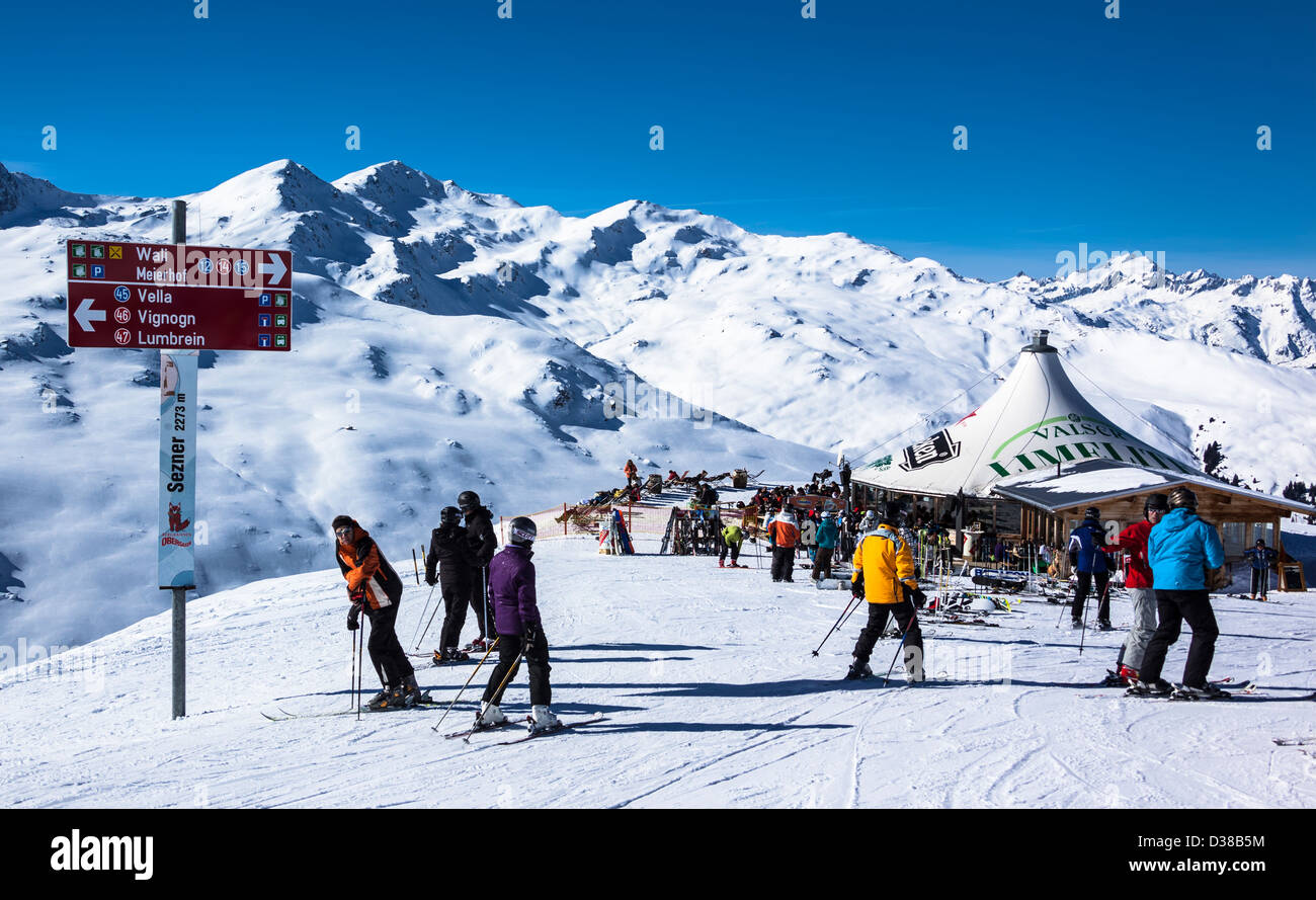 Skiers near open air bar on Obersaxen ski area, Grisons, Switzerland Stock Photo