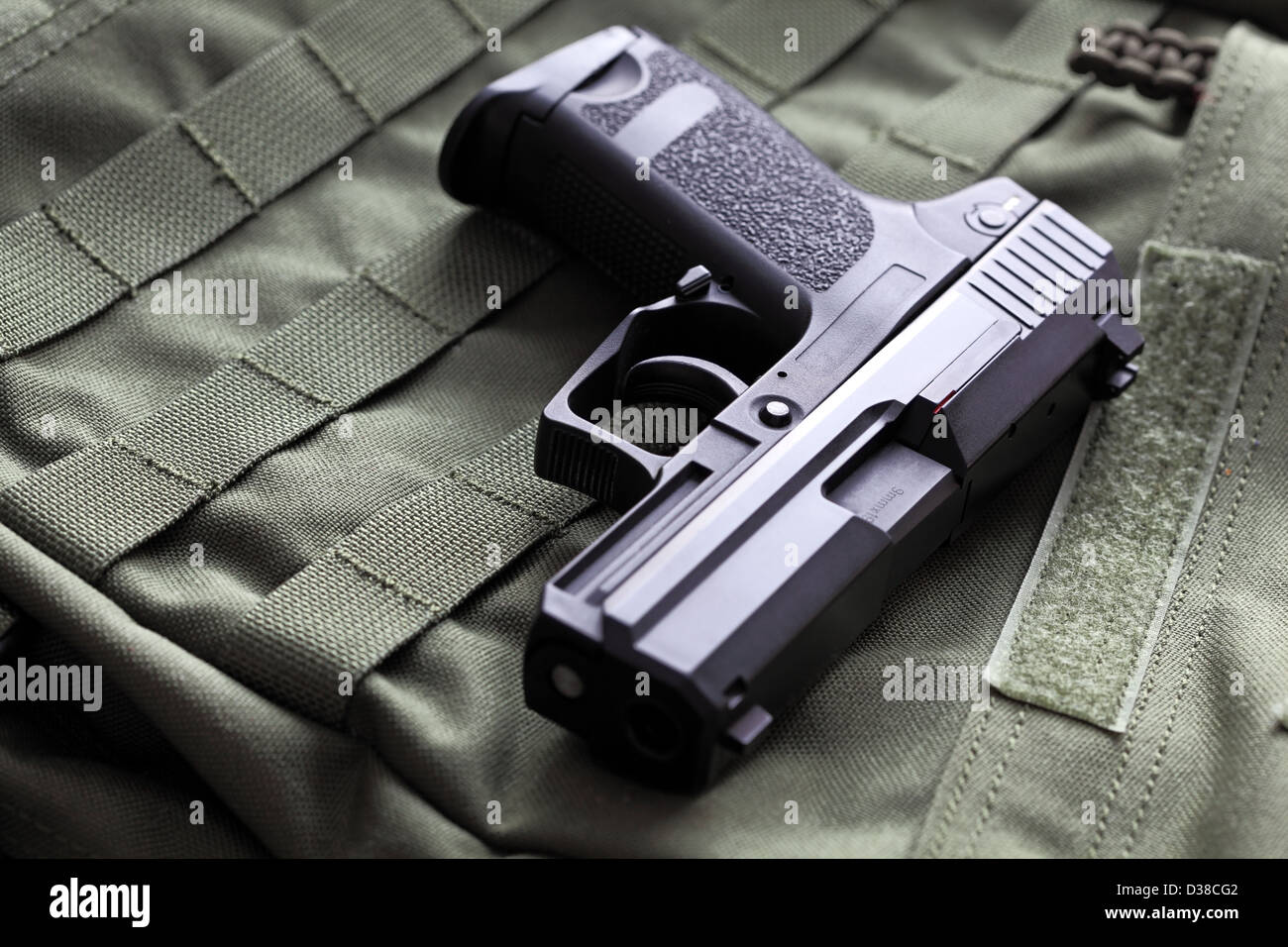 Weapon series. European 9mm semi-automatic USP Compact pistol on a green background. Studio shot. Stock Photo