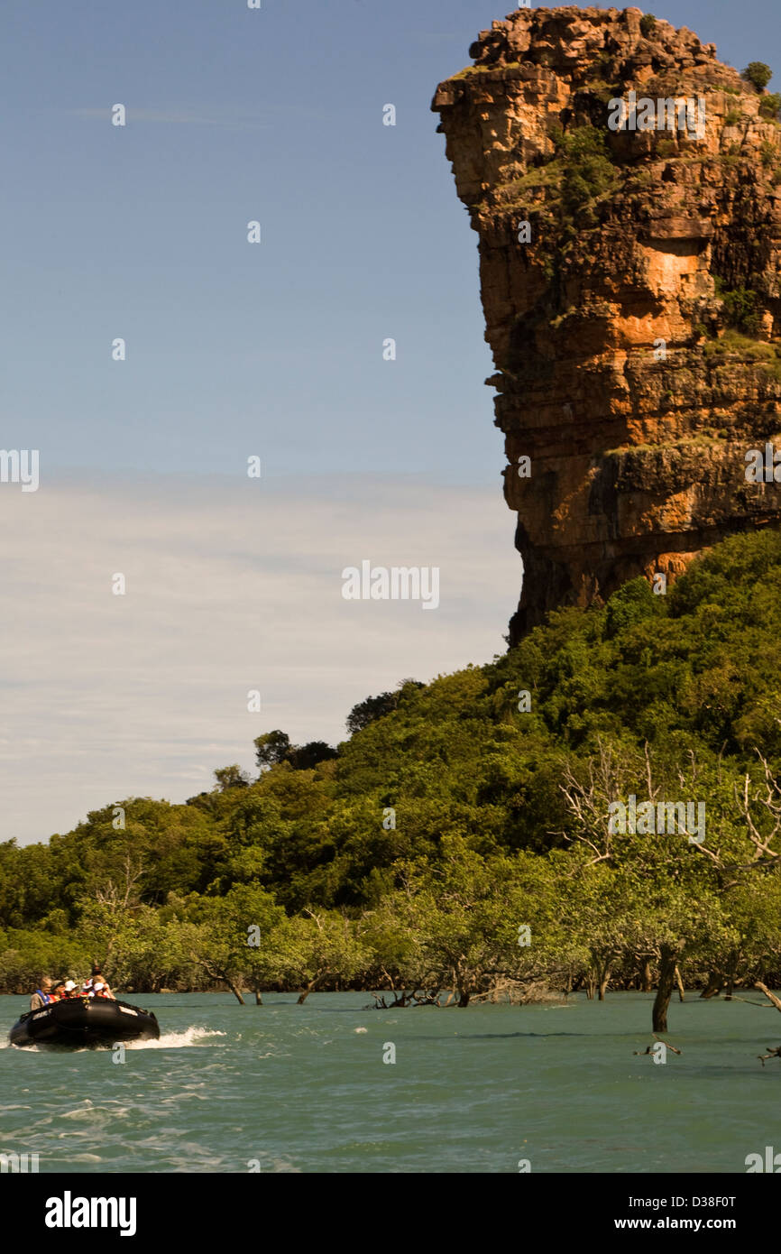 A Zodiac from the Aussie expedition cruiser Orion skims past Indian Head rock in Frederick Harbour, Western Australia Stock Photo