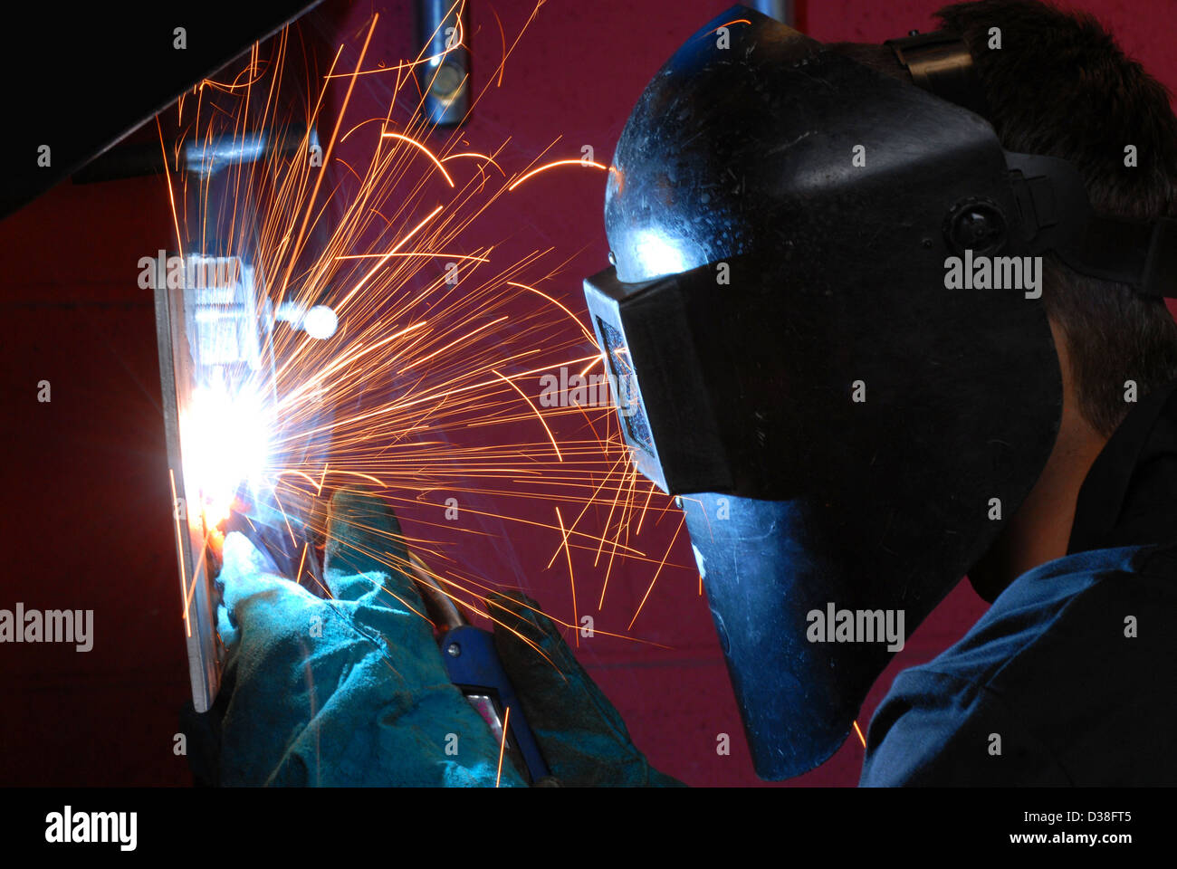 Man welding, fabrication, construction, building, sparks, danger, recession, engineering, making, work, employment, gdp, Stock Photo