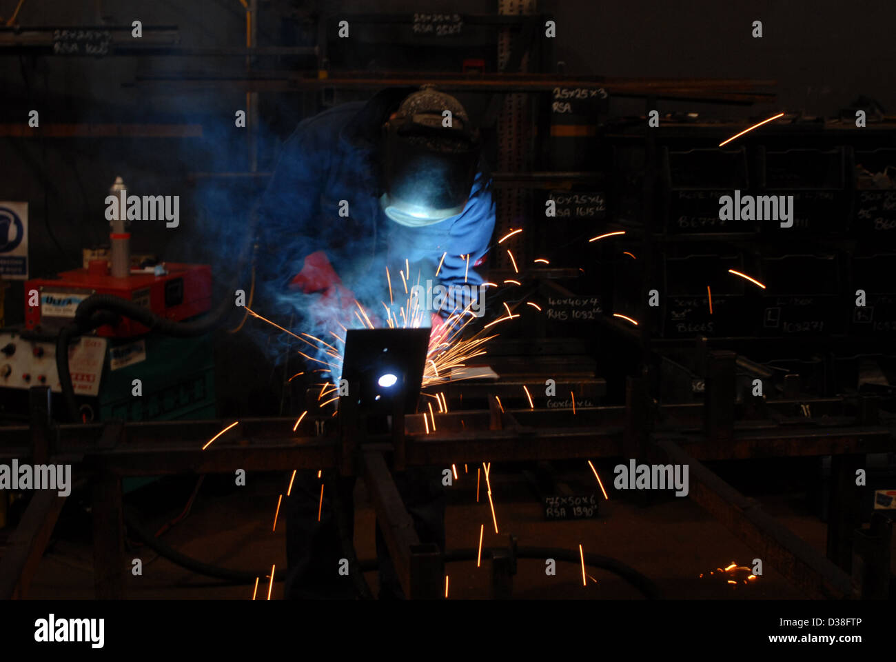 Man welding, fabrication, construction, building, sparks, danger, recession, engineering, making, work, employment, Stock Photo