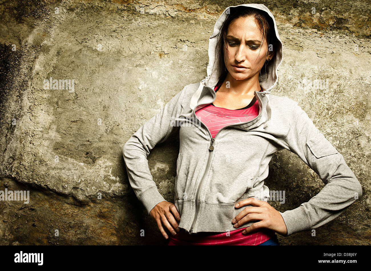 Runner resting on concrete wall Stock Photo Alamy