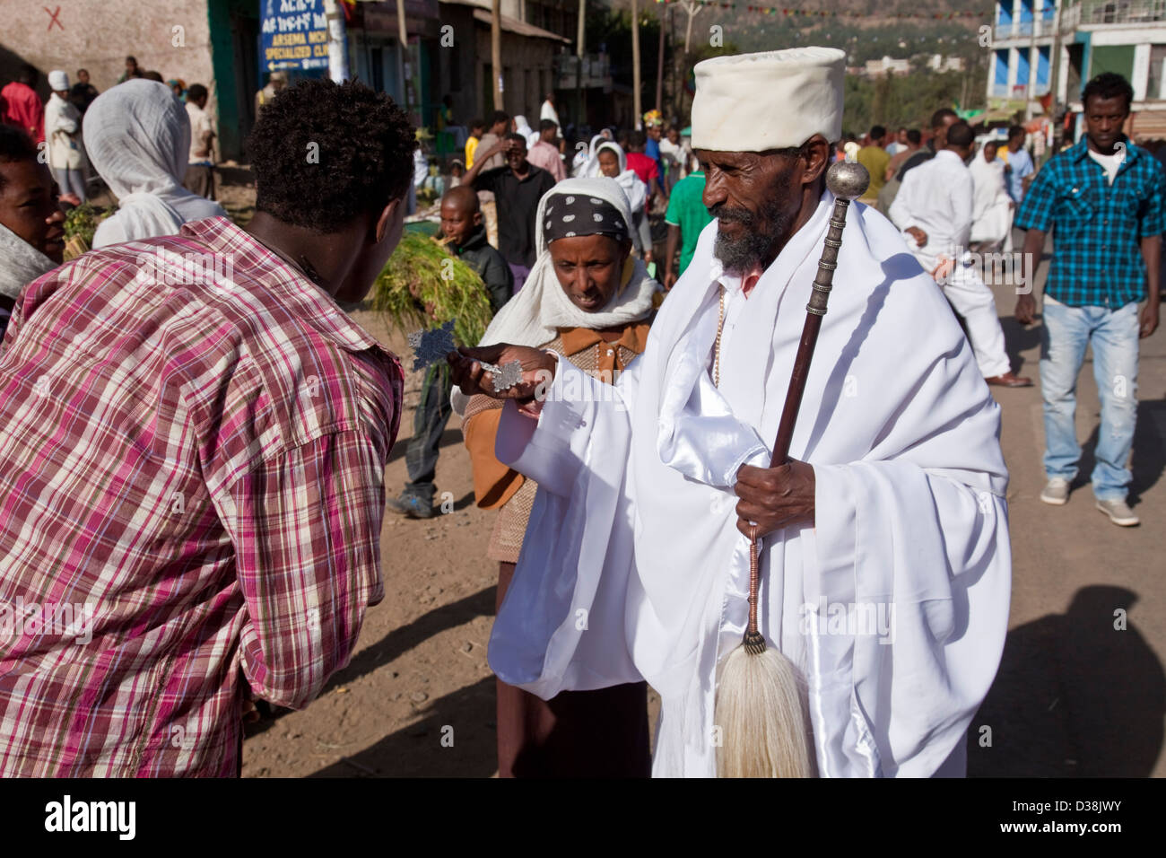 A man is blessed by a Priest in the street during the festival of Timkat, Gondar, Ethiopia Stock Photo