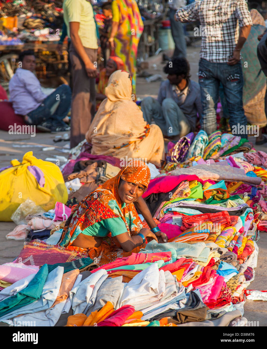 Street market in Jodhpur, Rajasthan, India: local woman selling colourful fabrics Stock Photo