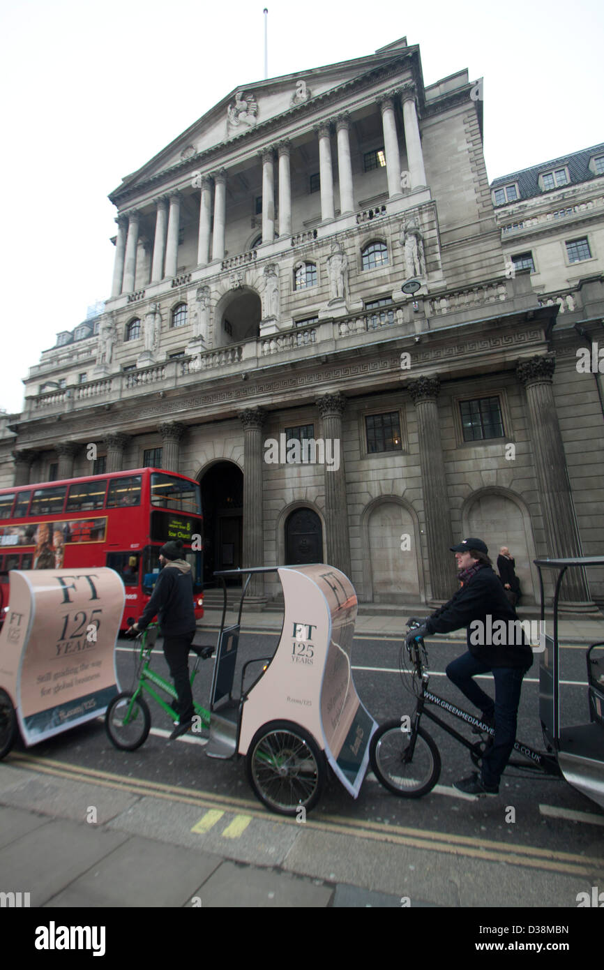 London, UK. 13th February 2013. Newspaper vendors on rickshaws distribute free copies of the first Financial Times outside the Bank of England in the city of London financial district. The Financial Times was first published on 13 February 1888 and celebrates its 125th anniversary with a special edition. Amer Ghazzal / Alamy Live News Stock Photo