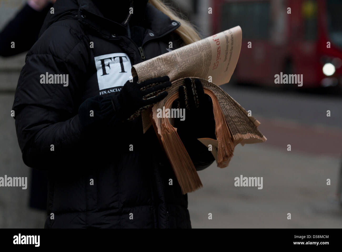 London, UK. 13th February 2013. A Newspaper vendor distributes free copies of the first Financial Times in the city of London financial district. The Financial Times was first published on 13 February 1888 and celebrates its 125th anniversary with a special edition. Amer Ghazzal / Alamy Live News Stock Photo