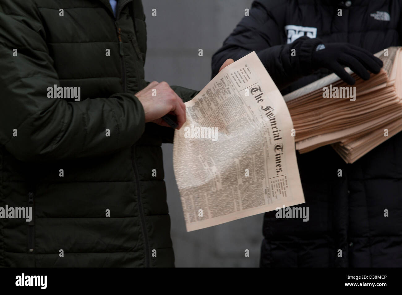 London, UK. 13th February 2013. A Newspaper vendor distributes free copies of the first Financial Times in the city of London financial district. The Financial Times was first published on 13 February 1888 and celebrates its 125th anniversary with a special edition. Amer Ghazzal / Alamy Live News Stock Photo