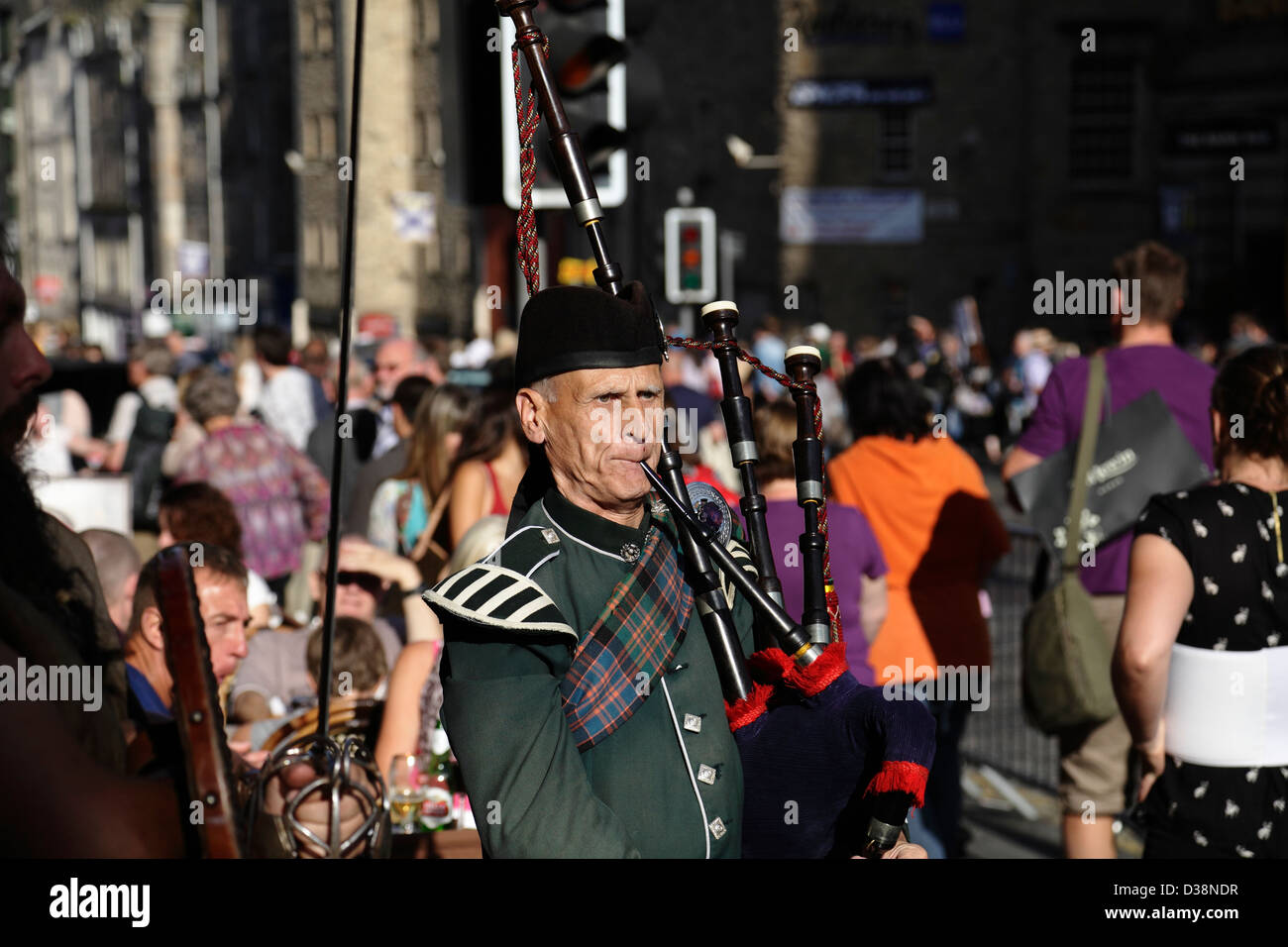 A musician playing bagpipes on the Royal Mile during the Edinburgh