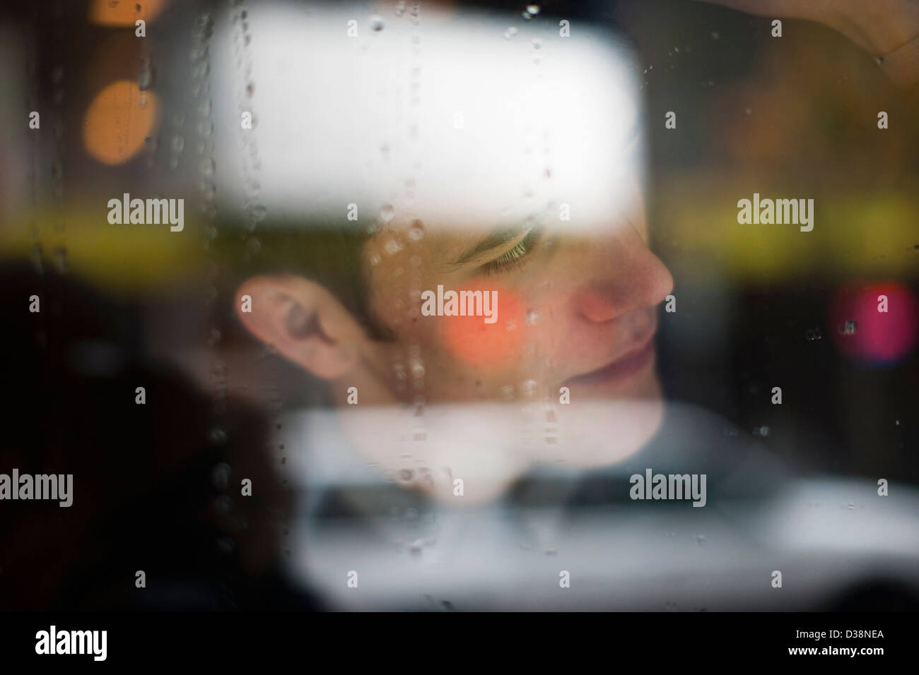 Man viewed through wet glass Stock Photo