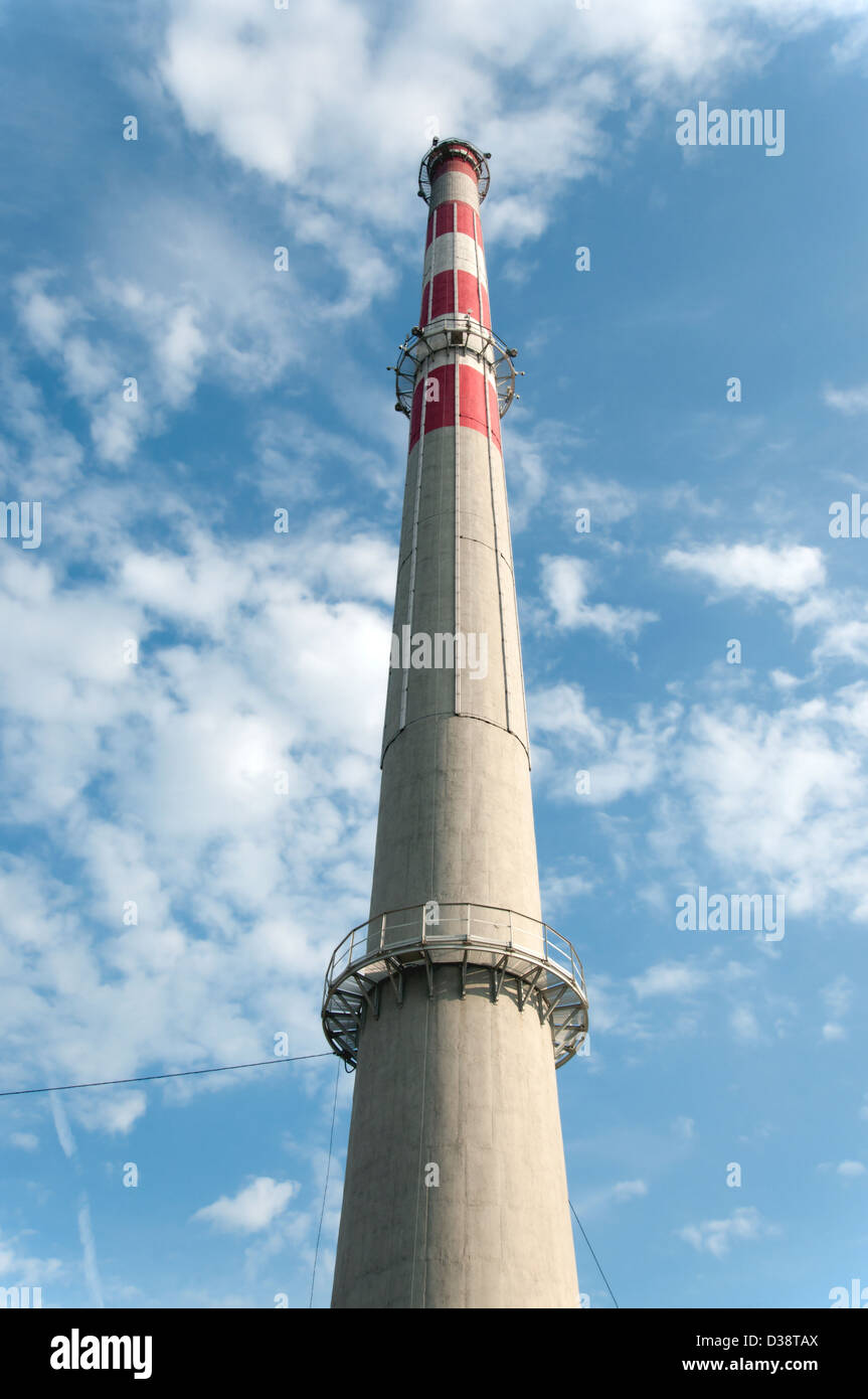 Clean factory chimney on blue sky with white clouds Stock Photo - Alamy