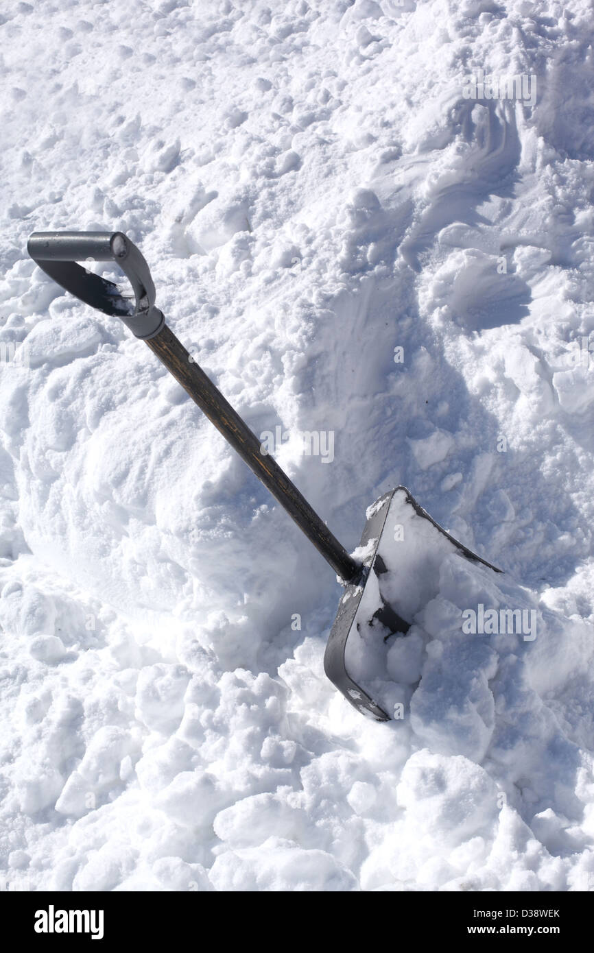 Shoveling snow from driveway shovel in snow Stock Photo Alamy