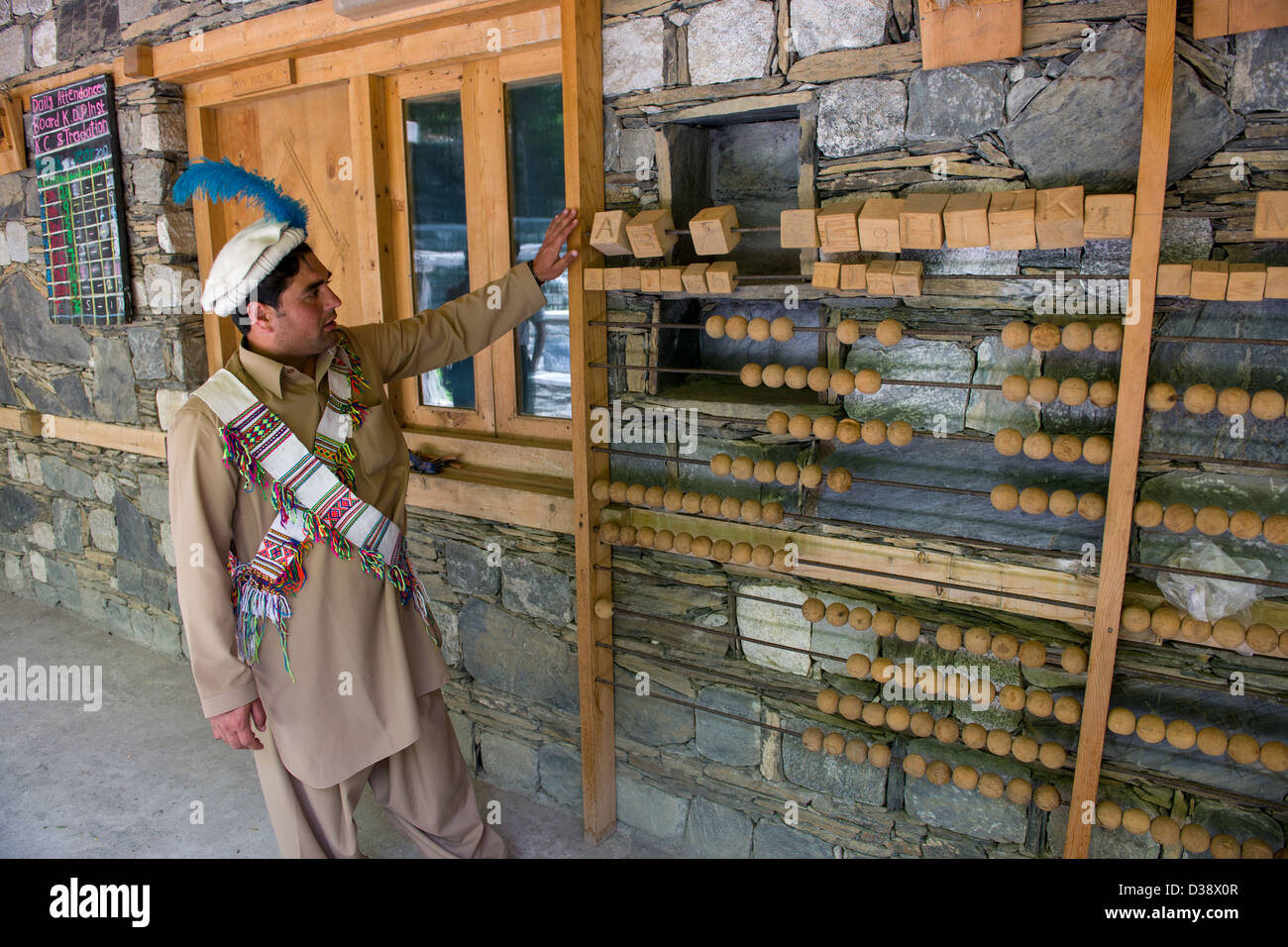 Akram Hussain Kalash, a curator demonstrating the school abacas at the Kalasha-dur museum, Darasguru Village, Bumburet Valley, Chitral, Khyber-Pakhtunkhwa, Pakistan Stock Photo