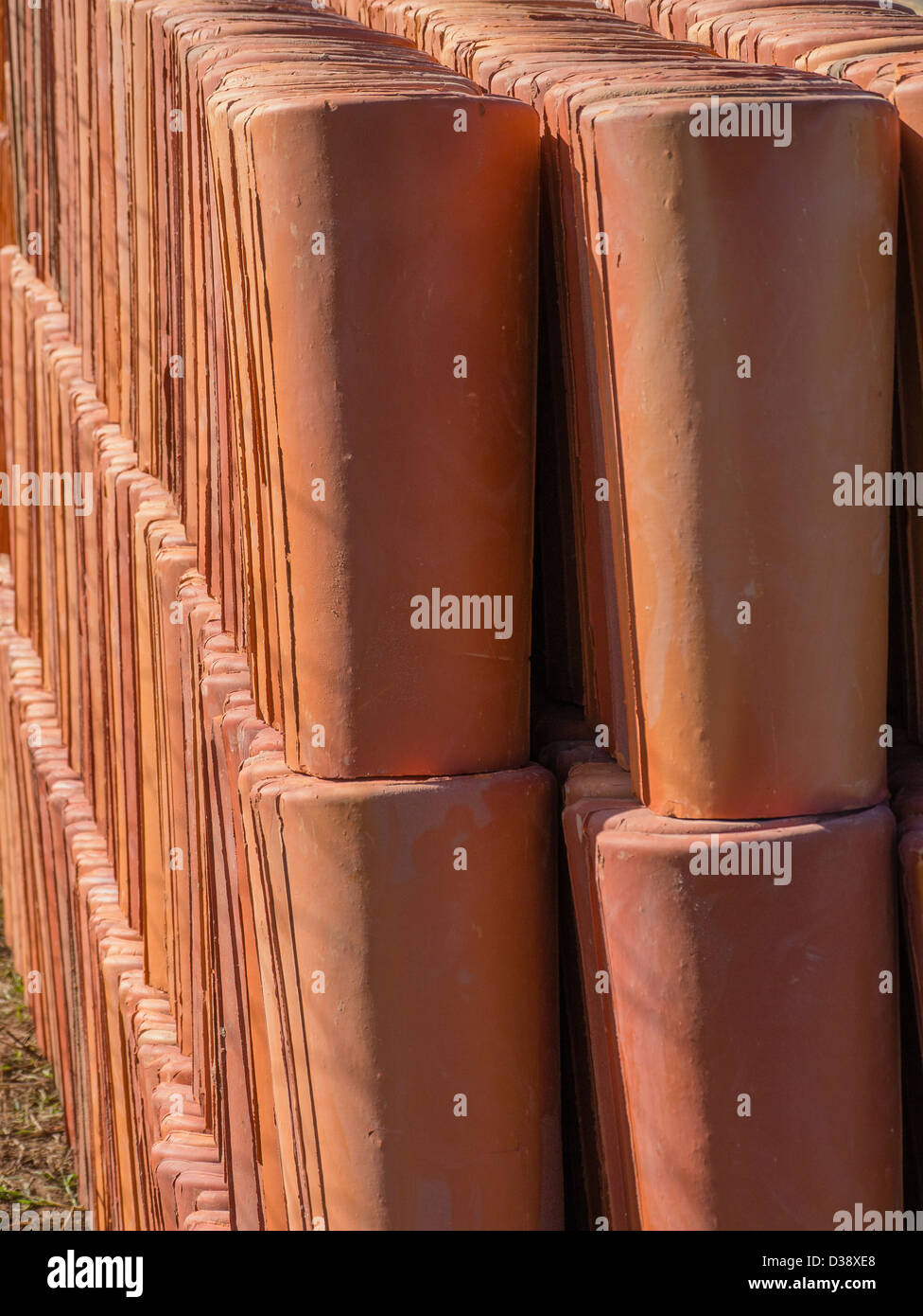 Red ceramic roof tiles stacked up at a job site for a Habitat for Humanity house building project in Luque, Paraguay. Stock Photo