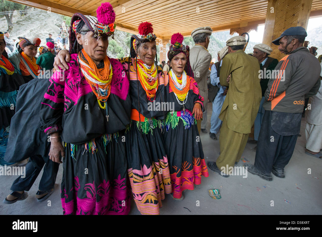 Kalash women dancing in a line at the Kalash Joshi (Spring Festival), Grum Village Charso (dancing ground), Rumbur Valley, Chitral, Khyber-Pakhtunkhwa, Pakistan Stock Photo