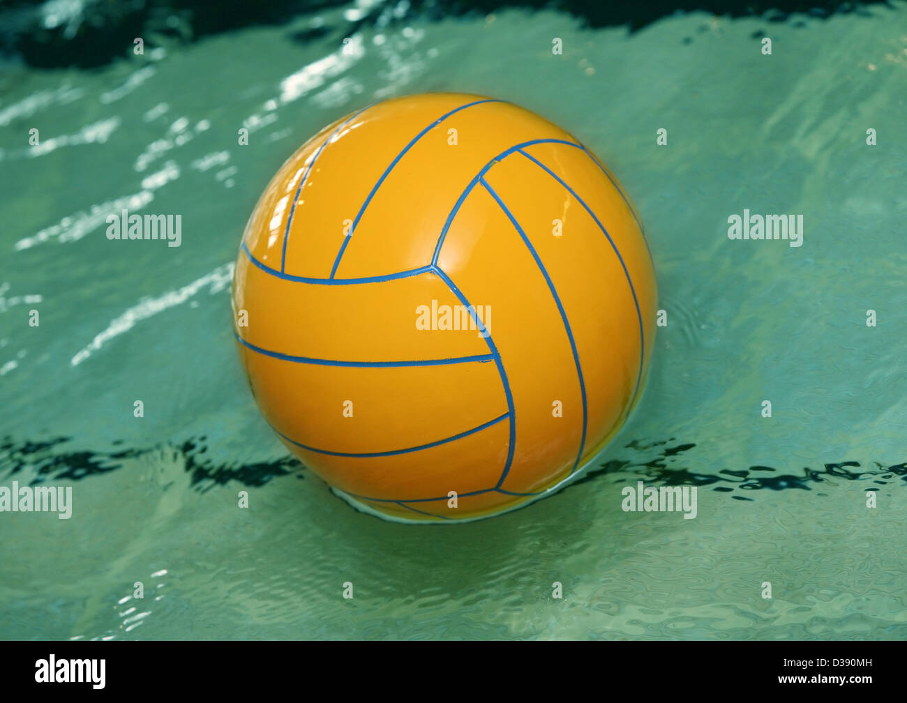 Yellow water polo ball rests in a of blue water Stock Photo Alamy