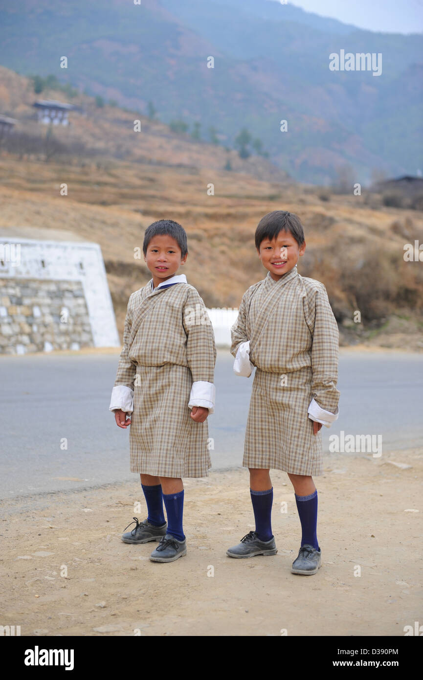 Two boys on their way home from school in school uniform this is also