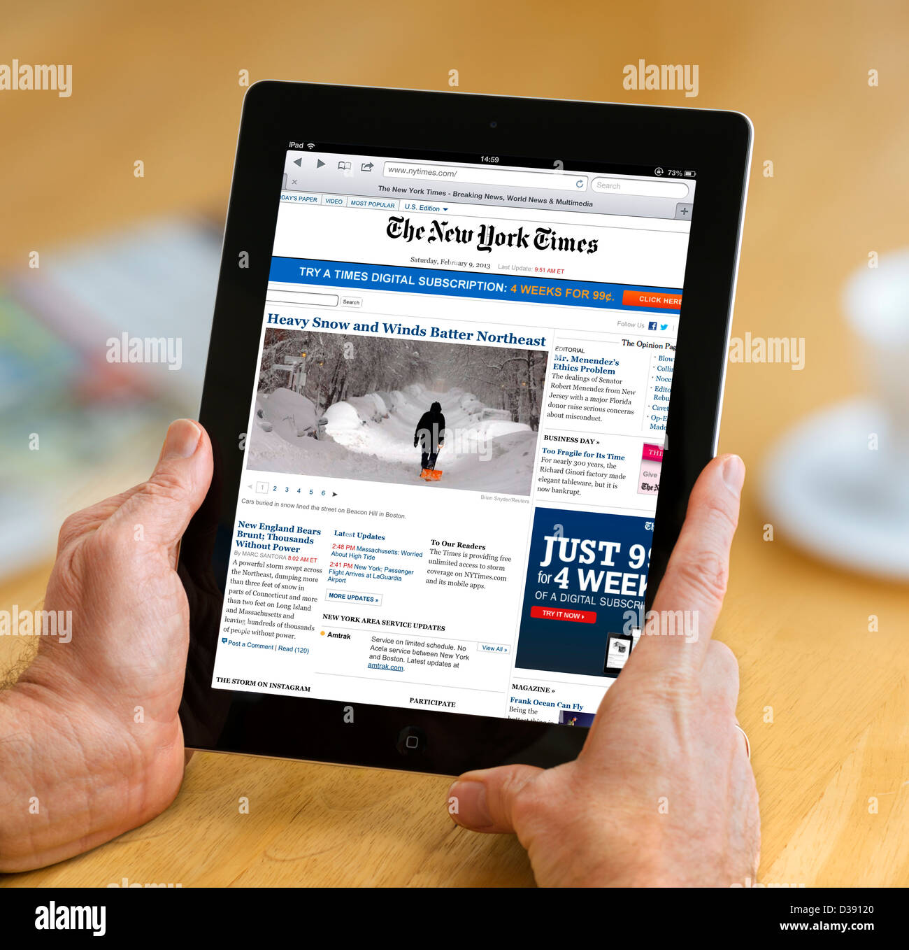 Reading the online edition of the New York Times viewed on a 4th generation Apple iPad, USA Stock Photo