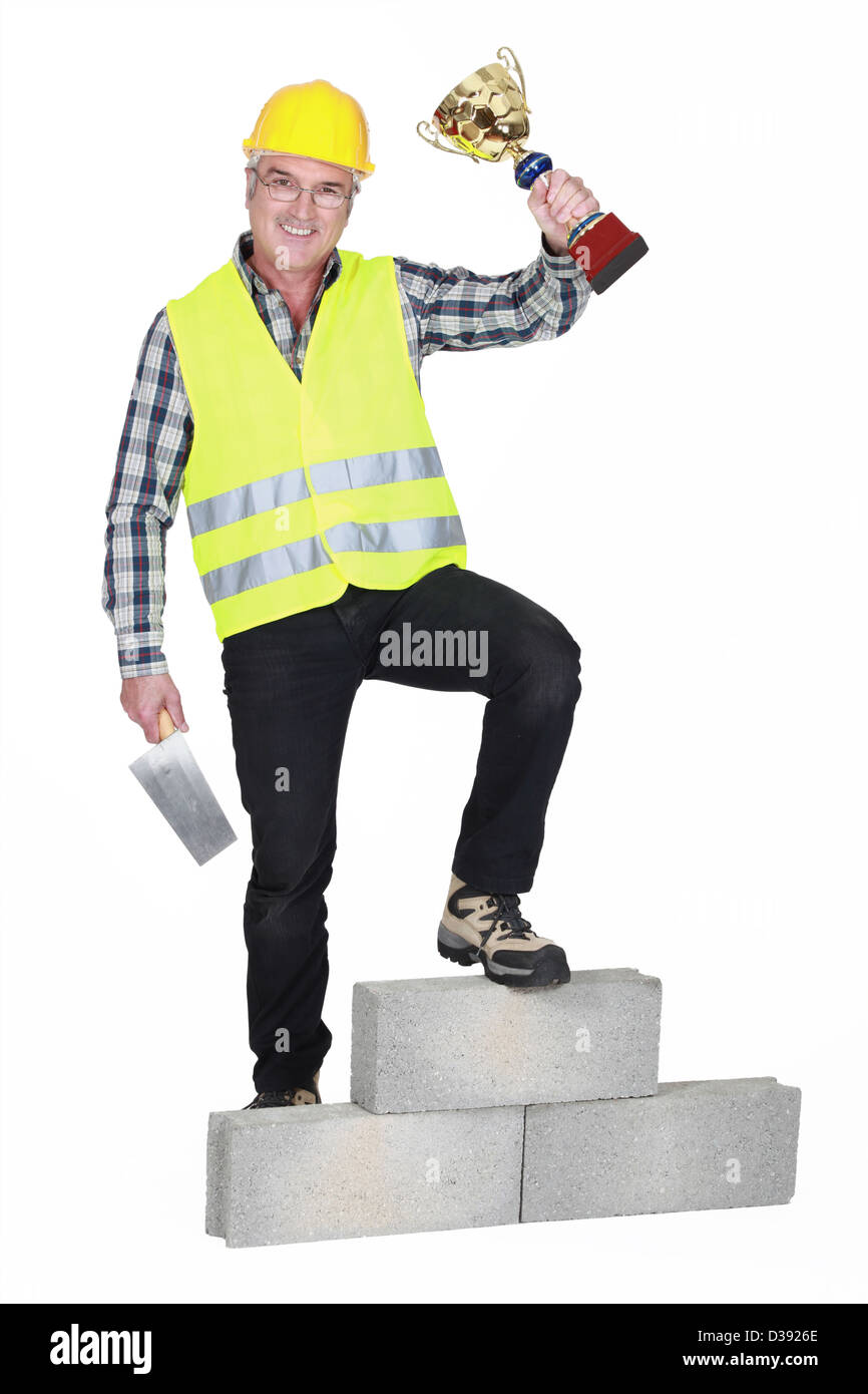 Successful laborer on a podium Stock Photo - Alamy