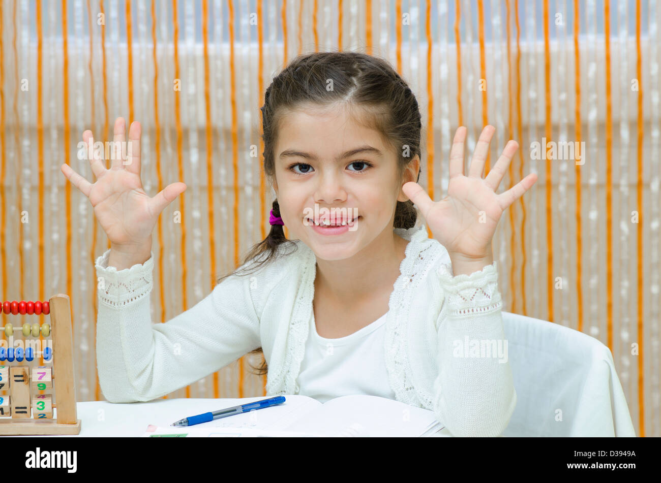 A schoolgirl at her desk with abacus Stock Photo - Alamy