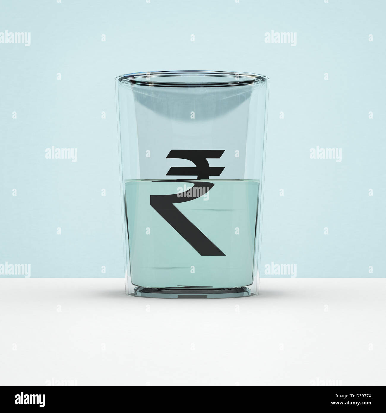 Glass half full with rupee symbol representing hope of currency growth Stock Photo
