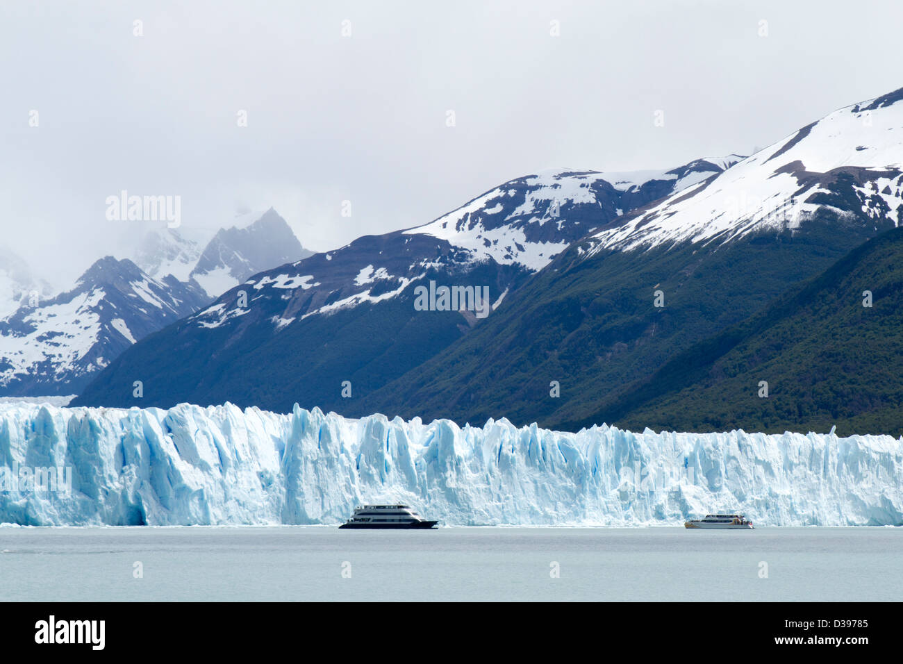 Cruise boats sit idle in front of the towering Perito Moreno glacier in Patagonia, Argentina Stock Photo