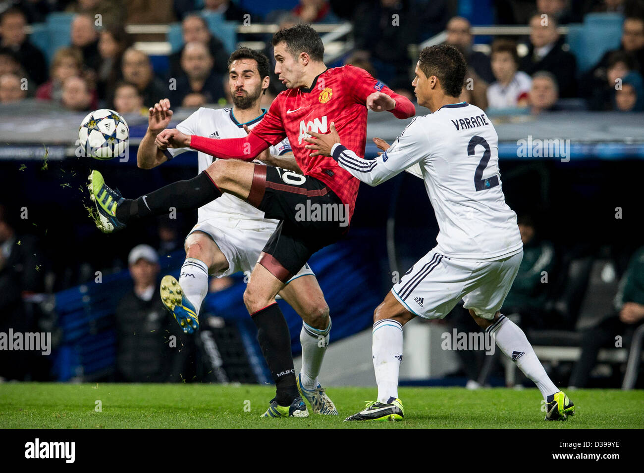Madrid, Spain. 13th February 2013.   Forward Robin van Persie of Manchester United is  challenged by Defender Alvaro Arbeloa of Real Madrid (L) and Defender Varane of Real Madrid during the Champions League game between Real Madrid and Manchester United Saint Germain from the Mestalla Stadium. Credit:  Action Plus Sports Images / Alamy Live News Stock Photo