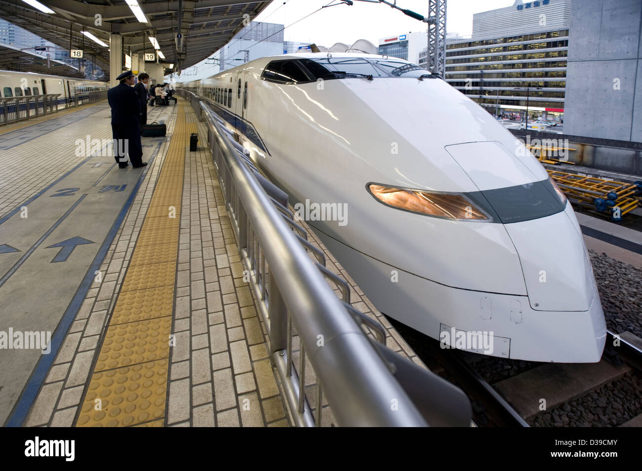 Sleek, white Japan Railways shinkansen super-express bullet train awaits at the platform in Tokyo Station. Stock Photo