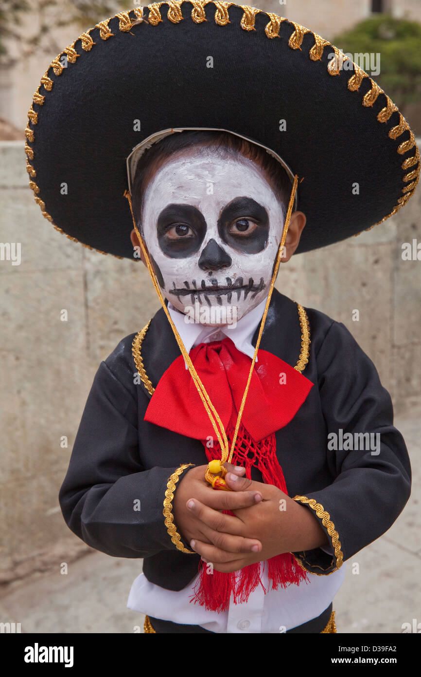 Young boy with face painted and dressed in traditional costume for Day of the Dead children's parade, in Oaxaca, Mexico. Stock Photo