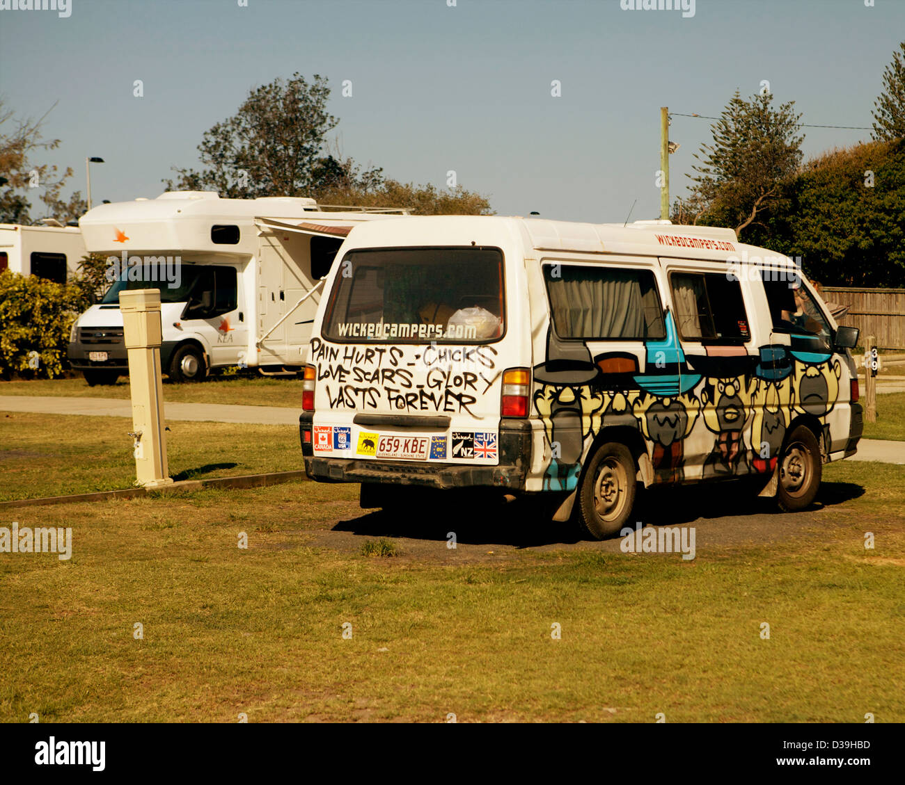 Volkswagen Campervan covered in graffiti as part of the company quirky branding parked at a campsite in Byron Bay, NSW, Australia. Stock Photo