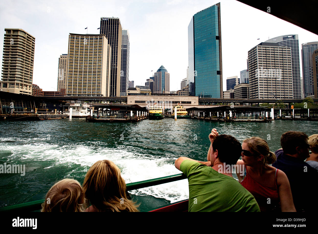 People looking at the Sydney skyline as the Sydney Ferry pulls out of Circular Quay, Sydney Australia Stock Photo