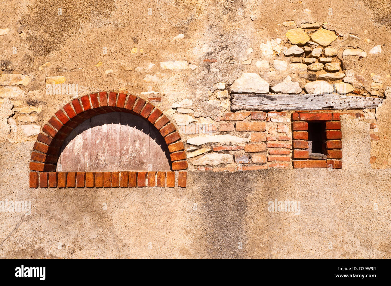 Old brick arch in wall - France. Stock Photo