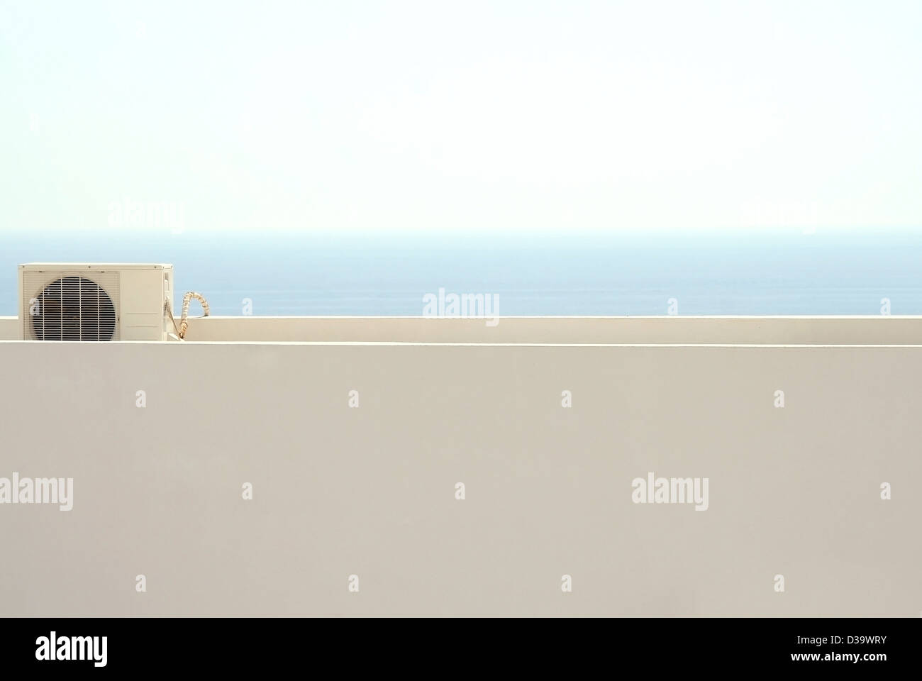 Air handling unit at a flat roof, in the back the Horizon above the ozean Stock Photo