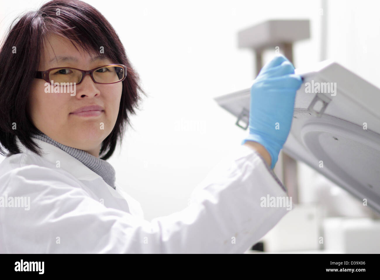 Scientist using equipment in lab Stock Photo