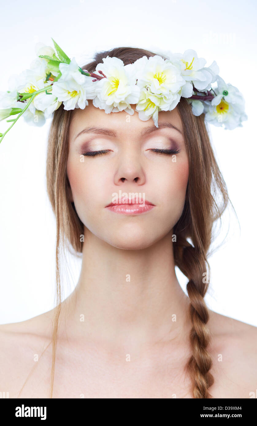 Portrait of beautiful young woman with closed eyes wearing floral ...