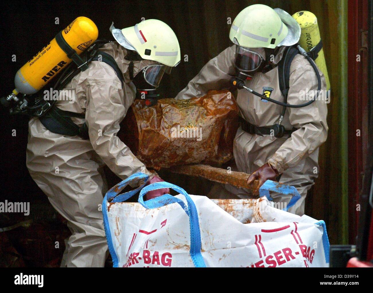 Two specialists of the German fire brigade wear protective clothing ...